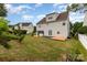Home exterior showcasing a backyard with green grass, and a stylish deck for outdoor living at 13305 Mallard Landing Rd, Charlotte, NC 28278