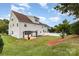 Back exterior showing a well-maintained lawn, deck, creating a serene outdoor space at 13305 Mallard Landing Rd, Charlotte, NC 28278