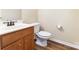 This half bath features a cherry vanity and wood flooring at 13305 Mallard Landing Rd, Charlotte, NC 28278