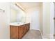 Bathroom featuring a double vanity, tile floors, and a large mirror at 13305 Mallard Landing Rd, Charlotte, NC 28278