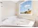 A close up of a bathtub with jets, next to a bright window at 13305 Mallard Landing Rd, Charlotte, NC 28278