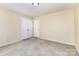 Comfortable bedroom featuring carpet floors, closet and paneled door painted white at 13305 Mallard Landing Rd, Charlotte, NC 28278