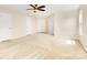 Large bedroom featuring carpet floors, three doors, and ceiling fan at 13305 Mallard Landing Rd, Charlotte, NC 28278