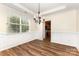 Formal dining room with large window for natural light and hardwood floors at 13305 Mallard Landing Rd, Charlotte, NC 28278