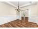 Traditional dining room with elegant chandelier, wainscoting, and hardwood floors at 13305 Mallard Landing Rd, Charlotte, NC 28278