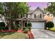 Charming two-story home with a brick facade, manicured landscaping, and a two-car garage at 13305 Mallard Landing Rd, Charlotte, NC 28278