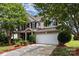 Charming two-story home featuring a brick facade, well-maintained landscaping, and an attached two-car garage at 13305 Mallard Landing Rd, Charlotte, NC 28278
