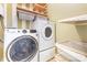 Convenient laundry room with modern washer and dryer and shelving for storage at 13305 Mallard Landing Rd, Charlotte, NC 28278
