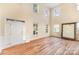 Bright living room with soaring ceilings, large windows, and elegant hardwood floors at 13305 Mallard Landing Rd, Charlotte, NC 28278