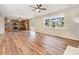 Open floor plan featuring a kitchen, dining area, and living room with hardwood floors and modern lighting at 13305 Mallard Landing Rd, Charlotte, NC 28278
