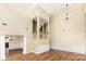 Open-concept living room with high ceilings, hardwood floors, and elegant lighting fixtures at 13305 Mallard Landing Rd, Charlotte, NC 28278