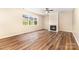 Bright living room features a fireplace, ceiling fan, and large window offering lots of natural light at 13305 Mallard Landing Rd, Charlotte, NC 28278