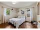 Cozy bedroom with hardwood floors, white bedding, and bright windows at 1344 Shannonhouse Dr, Charlotte, NC 28215