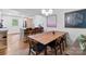 Open-concept dining room featuring a wooden table, pendant lighting, and modern design at 1344 Shannonhouse Dr, Charlotte, NC 28215