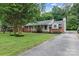 Attractive single-story home with a lush green lawn and long driveway at 1344 Shannonhouse Dr, Charlotte, NC 28215