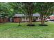 Charming home with brick accents, a well-manicured lawn, and mature trees at 1344 Shannonhouse Dr, Charlotte, NC 28215