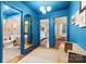 Hallway featuring blue walls leading to a full bathroom and bedrooms; hardwood floors at 1344 Shannonhouse Dr, Charlotte, NC 28215