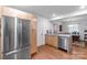 Contemporary kitchen with stainless steel refrigerator and hardwood flooring at 1344 Shannonhouse Dr, Charlotte, NC 28215