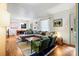 Bright living room with hardwood floors, large sofa, and dining area in background at 1344 Shannonhouse Dr, Charlotte, NC 28215