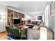 Open living room featuring hardwood floors, large sofa, and a bookcase at 1344 Shannonhouse Dr, Charlotte, NC 28215