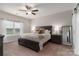 Spacious bedroom with large window, ceiling fan, and stylish neutral decor at 148 Kerri Dawn Ln, Locust, NC 28097