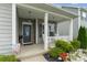 Inviting front porch with a welcome sign and decorative plants at 148 Kerri Dawn Ln, Locust, NC 28097