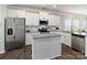 Well-lit kitchen features white cabinetry, stainless appliances, and a central island at 148 Kerri Dawn Ln, Locust, NC 28097