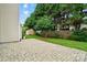 Backyard featuring a stone paver patio and a lush lawn with mature trees at 1522 Napa Nw St, Concord, NC 28027