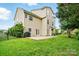 Spacious backyard with a patio, lush green lawn, and a home's exterior at 1522 Napa Nw St, Concord, NC 28027