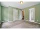 Bedroom with neutral paint, two windows, carpeted floor, and multiple doors at 1522 Napa Nw St, Concord, NC 28027