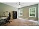 Bright bedroom with a ceiling fan, neutral carpeting, large windows and a dark desk at 1522 Napa Nw St, Concord, NC 28027