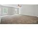 Large bedroom with a ceiling fan and two windows providing natural light at 1522 Napa Nw St, Concord, NC 28027