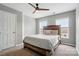 Cozy bedroom with a ceiling fan, neutral carpeting, large windows, and natural light at 1522 Napa Nw St, Concord, NC 28027