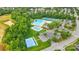 Aerial view of a community pool, tennis courts, basketball court, and parking at 1522 Napa Nw St, Concord, NC 28027