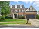 Traditional two-story brick home featuring a manicured lawn and attached two-car garage at 1522 Napa Nw St, Concord, NC 28027