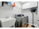 Functional laundry room with modern machines, sink, and storage cabinets, making laundry tasks convenient at 1522 Napa Nw St, Concord, NC 28027