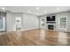 Spacious living room with a modern fireplace, hardwood floors, and natural light at 1522 Napa Nw St, Concord, NC 28027