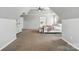 Large main bedroom featuring neutral carpeting, tray ceilings, a ceiling fan, and ample closet space at 1522 Napa Nw St, Concord, NC 28027