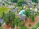 Aerial view of a community clubhouse and pool area surrounded by lush trees and residential homes at 200 Sweet Briar Dr, Fort Mill, SC 29707