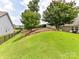 Spacious backyard with vibrant green grass, a fence, and beautiful crepe myrtle trees at 200 Sweet Briar Dr, Fort Mill, SC 29707