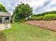Manicured backyard featuring lush grass, a crape myrtle tree, and a mulched garden bed at 200 Sweet Briar Dr, Fort Mill, SC 29707