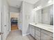 Bathroom featuring tile flooring, double sink vanity and closet with customized built-ins for ample storage at 200 Sweet Briar Dr, Fort Mill, SC 29707