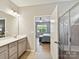 Bathroom featuring a double vanity, tiled floors, and a view into the bedroom at 200 Sweet Briar Dr, Fort Mill, SC 29707