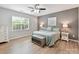Cozy bedroom with a ceiling fan, a large window, and a calming gray accent wall at 200 Sweet Briar Dr, Fort Mill, SC 29707