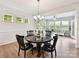 Elegant dining area with a chandelier and views into the bright and airy living room at 200 Sweet Briar Dr, Fort Mill, SC 29707
