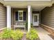 Inviting front porch with white columns, a cozy bench, and a decorative front door at 200 Sweet Briar Dr, Fort Mill, SC 29707