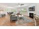 Spacious living room with fireplace, large windows, hardwood floors, and open-concept layout at 200 Sweet Briar Dr, Fort Mill, SC 29707