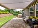 Relaxing outdoor patio with comfortable seating, a retractable awning, and a view of the landscaped backyard at 200 Sweet Briar Dr, Fort Mill, SC 29707
