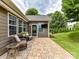 Charming outdoor patio with brick pavers, wicker furniture, and a wall mounted television at 200 Sweet Briar Dr, Fort Mill, SC 29707