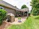 Outdoor patio area featuring a gas grill, comfortable seating, and a view of the landscaped backyard at 200 Sweet Briar Dr, Fort Mill, SC 29707